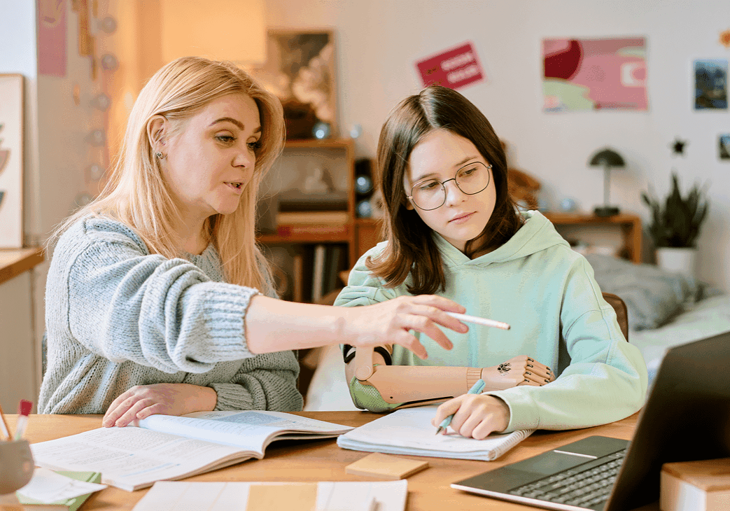 Woman tutoring girl at home